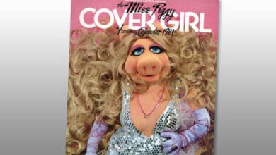 A magazine cover featuring Miss Piggy, a Muppet character, wearing a sparkling silver dress, long lavender gloves, and large earrings, with voluminous curly blonde hair. The title reads “Miss Piggy Cover Girl Fantasy Calendar 1981.”.