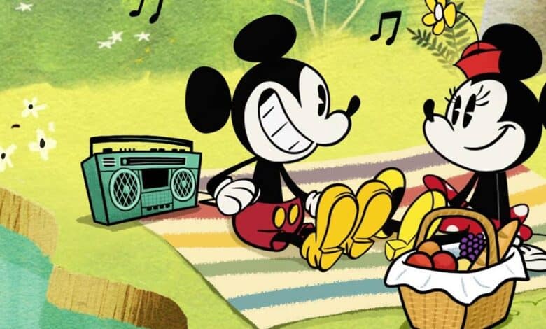 Mickey Mouse and Minnie Mouse sit on a striped picnic blanket by a pond, sharing bananas and fruit from a basket during their Picnic at Disney World, with a radio playing music and musical notes floating in the air.