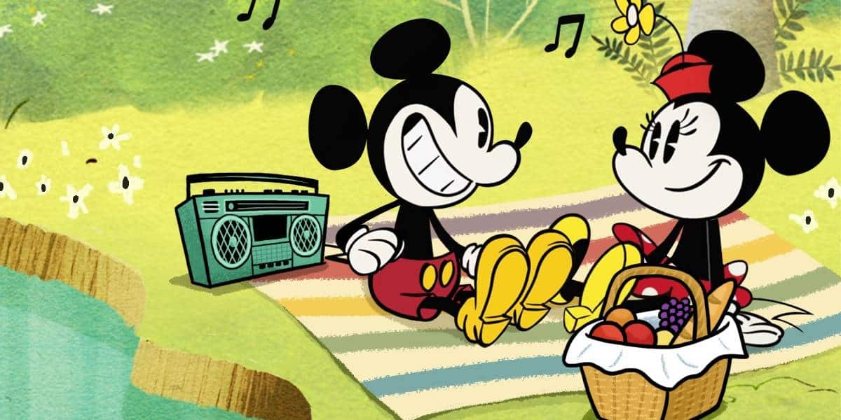 Mickey Mouse and Minnie Mouse sit on a striped picnic blanket by a pond, sharing bananas and fruit from a basket during their Picnic at Disney World, with a radio playing music and musical notes floating in the air.