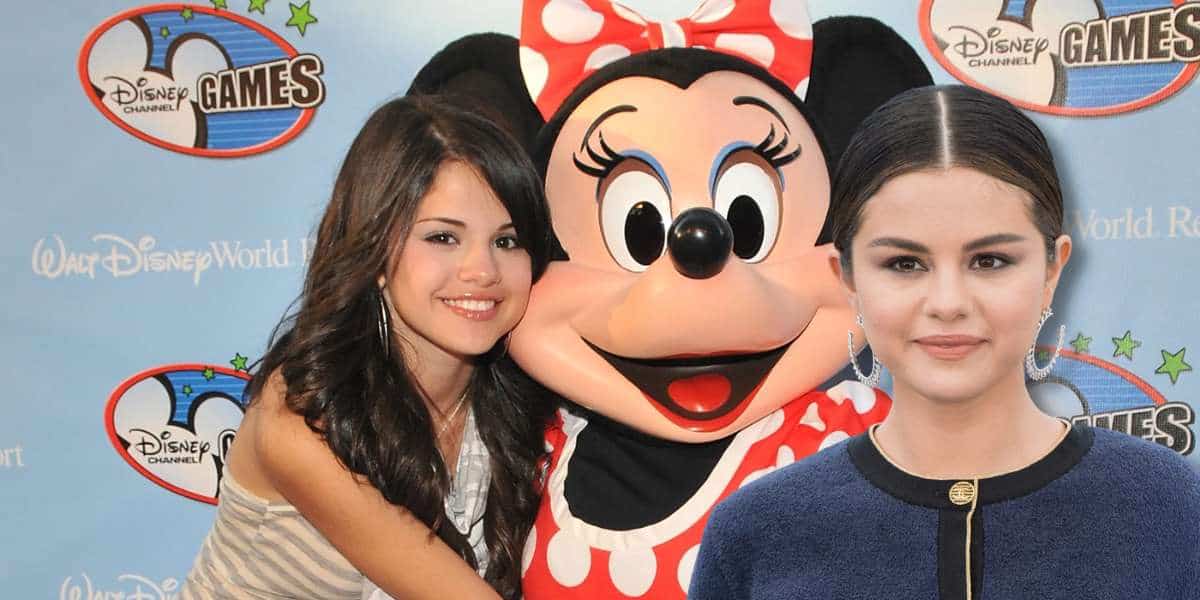 young selena gomez hugs a minnie mouse face character at the disney channel games premiere,