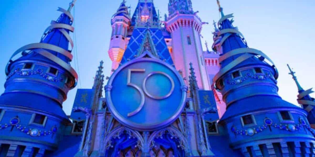 the front facade of cinderella castle with the 50 medallian