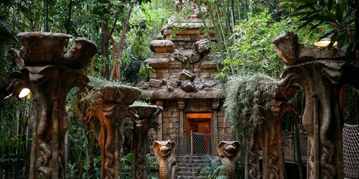 the jungle and temple of the forbidden eye in a step pyramid style of stone with snake statues