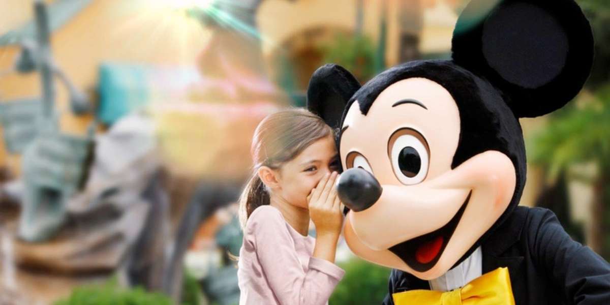 young white girl in pink long sleeve and ponytail whispers in mickey mouses eae