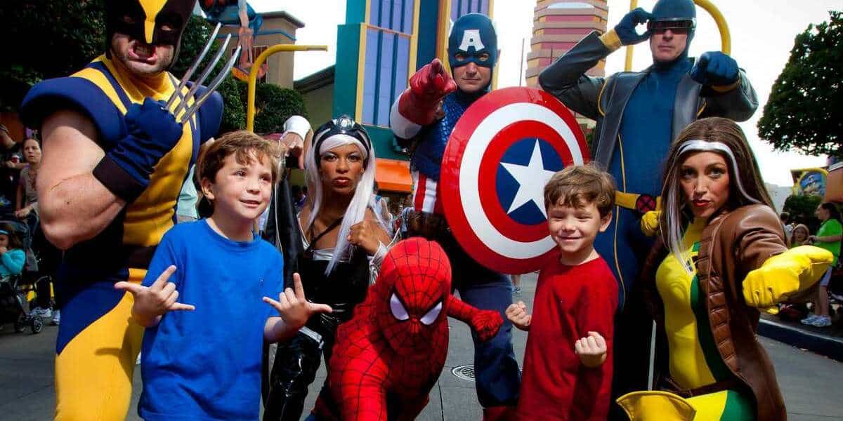 two young white boys with brown hair pose with universals marvel hero characters like captain america and the x men