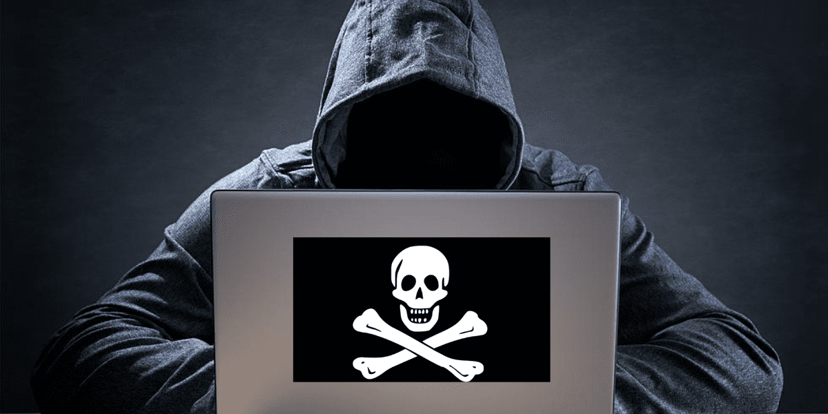 man with hoodie and laptop with pirate symbol illegal streaming