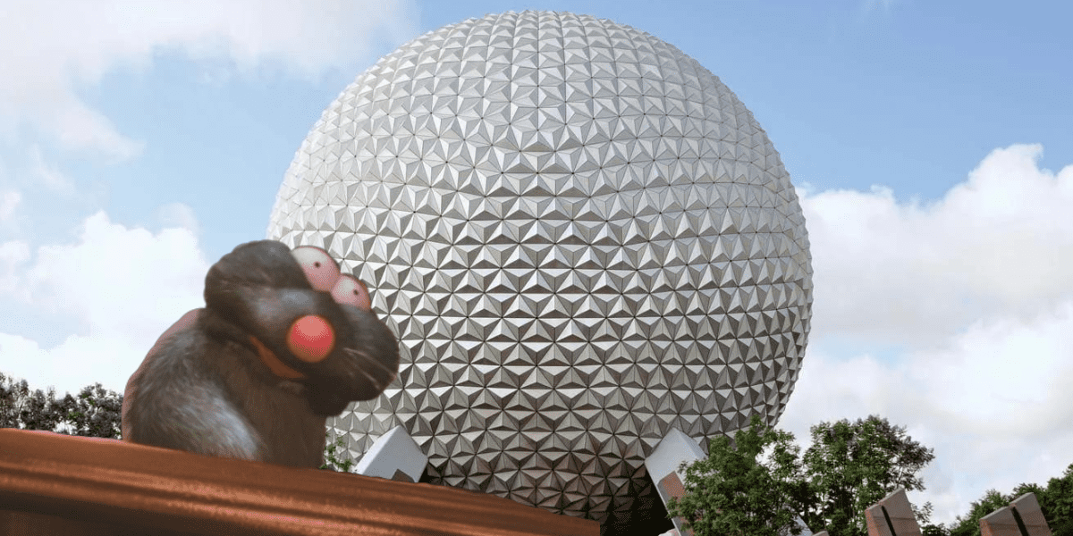 A startled rat-like animated character with bulging eyes looks towards the camera while standing in front of a massive geodesic sphere at Disney World. Trees and a clear, blue sky with a few clouds are visible in the background.
