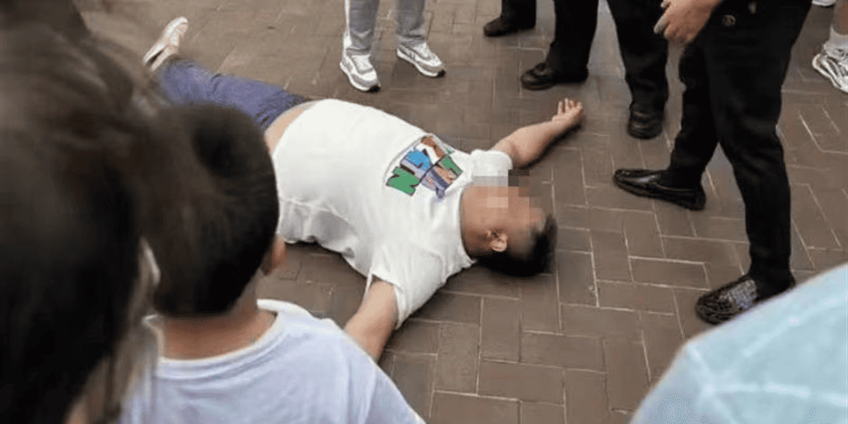 man lying on pavement at disney park