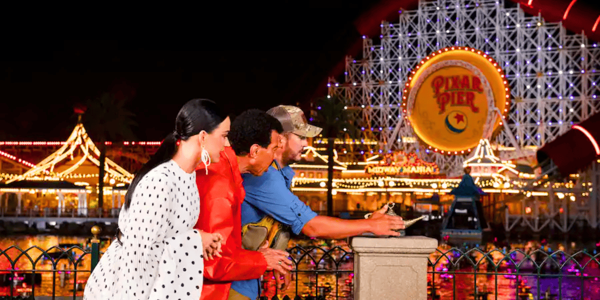 three people with aladdin genie lamp at pixar pier ferris wheel