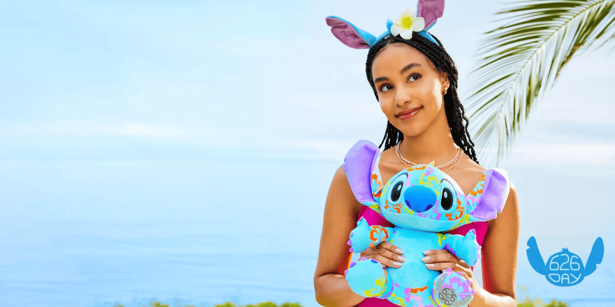 model wearing stitch merchandise and holding stitch plush