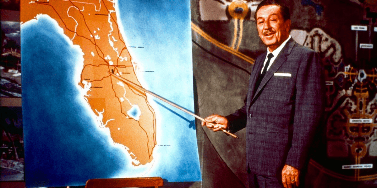 walt disney points to a map of central florida