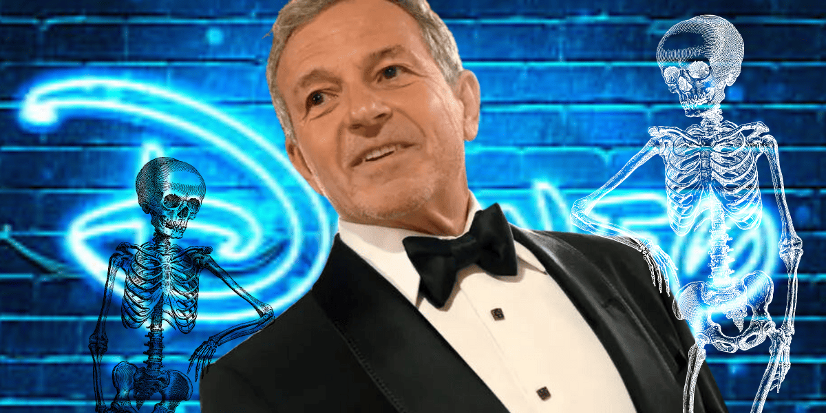 disney ceo bob iger wears tuxedo and has two skeletons leaning on him
