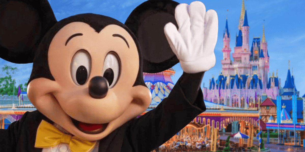 mickey waving in front of magic kingdom's fantasyland
