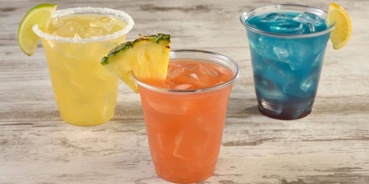 Three Disney cocktails with garnishes