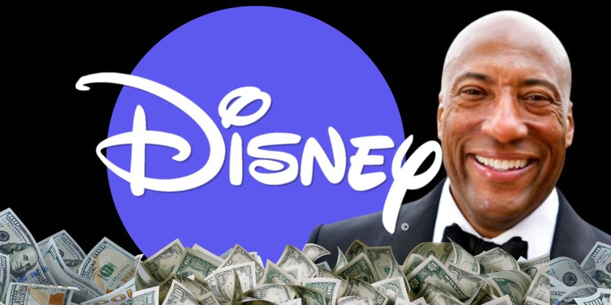 man in tuxedo stands in front of purple circle with disney logo and 100 dollar bills