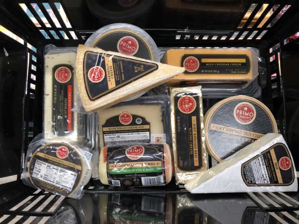 Variety of Primo Taglio cheeses in a basket.