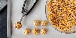 fried biscuits in the process of being made into balls with scoop