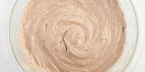 A close-up of whipped cinnamon butter in a glass bowl, featuring a "Grey Stuff" recipe-inspired creamy texture with a swirl pattern on top.