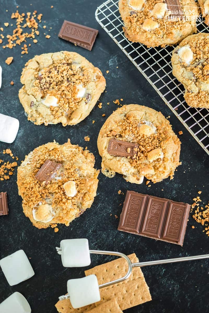 S'mores cookies next to marshmallows on a roasting stick.
