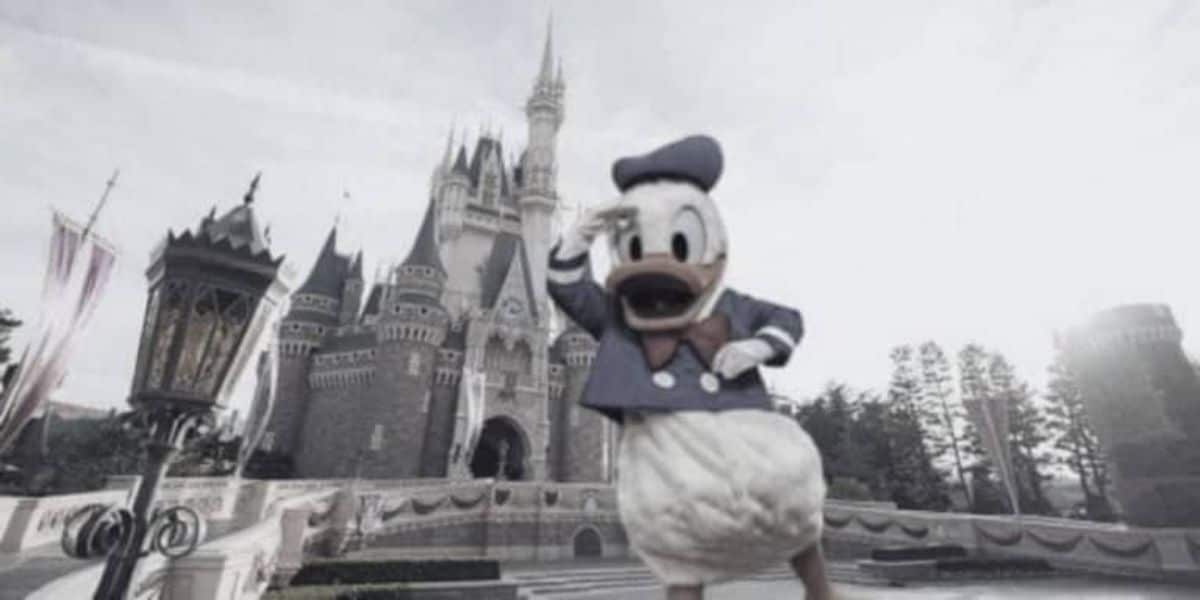 Donald Duck, dressed in his classic sailor outfit, stands cheerfully in front of a large, enchanting castle with multiple spires and turrets, likely a Disney castle. The scene appears bright and cheerful, embodying a fairytale-like ambiance.