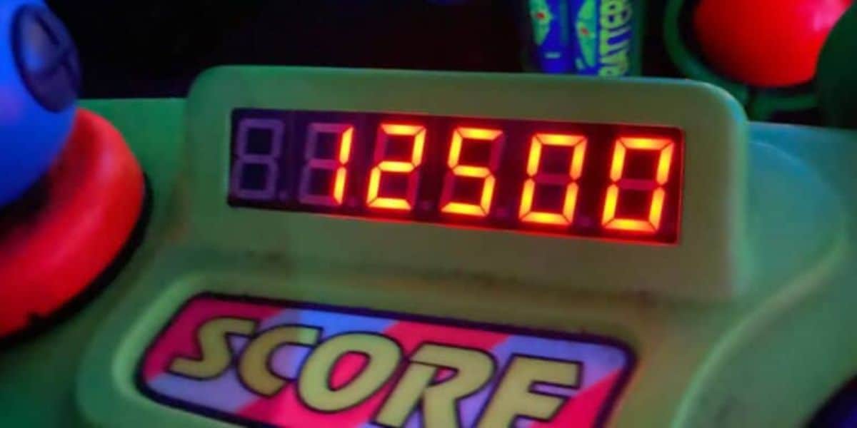 A digital scoreboard displaying a score of 125,800 in bright red numbers against a dark background. Below the numbers, a colorful label with the word "SCORE" is partially visible. The setup suggests it's part of an arcade or amusement game.
