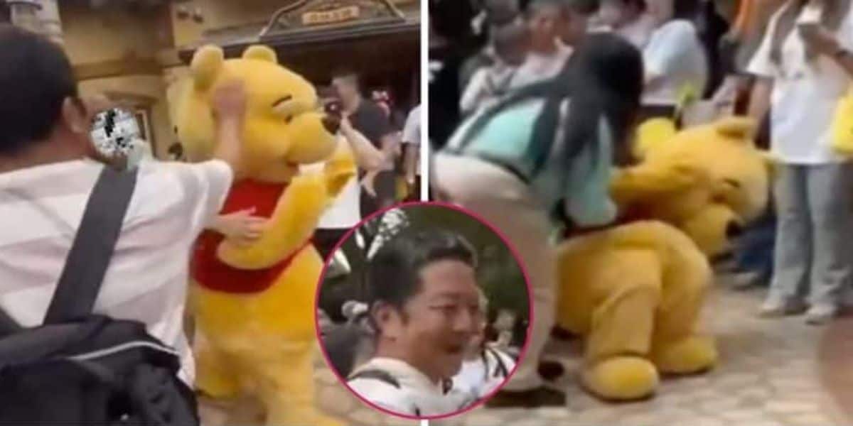 A person in a large Winnie the Pooh costume is surrounded by a crowd of people who are taking photos and interacting with the character. A woman appears to be helping adjust or fix the costume. There is a circular inset showing a person's face smiling.