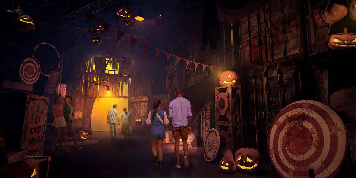 People walking through a dimly lit, spooky hallway decorated with glowing jack-o'-lanterns and eerie props. The atmosphere is reminiscent of a haunted house, with scattered carnival elements like a target board and festive lights at Universal Horror Unleashed in Las Vegas.