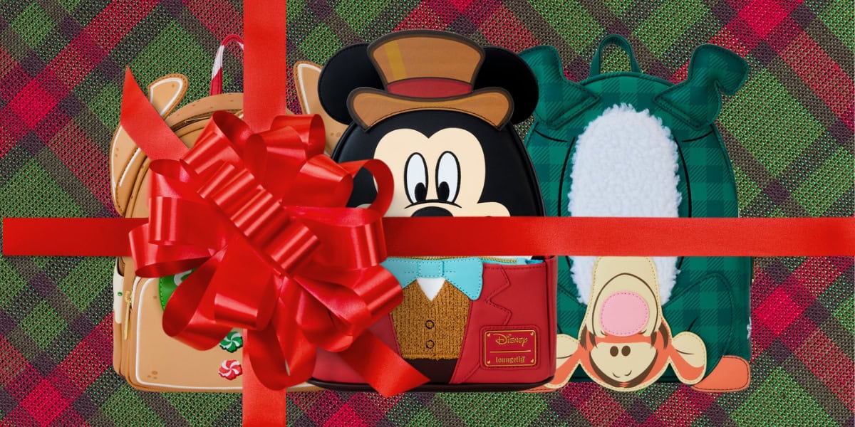 Three festive-themed backpacks designed as Disney characters are wrapped with a large red ribbon and bow. The background features a red and green plaid pattern, enhancing the holiday vibe.