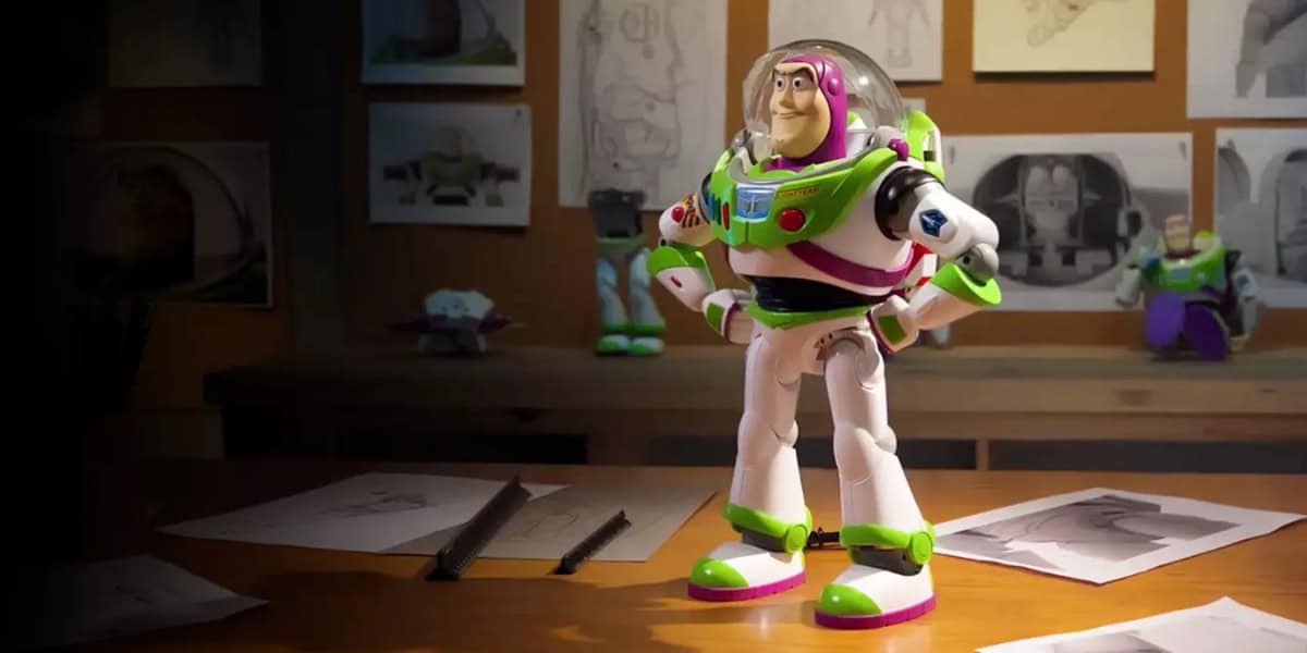 Buzz Lightyear stands on a creative Pixar desk surrounded by sketches and toys, evoking the magic of Toy Story Land.