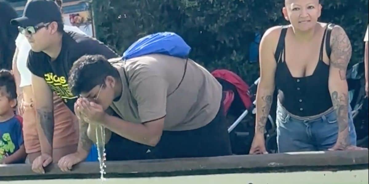 A man drinking tank water at SeaWorld San Diego.