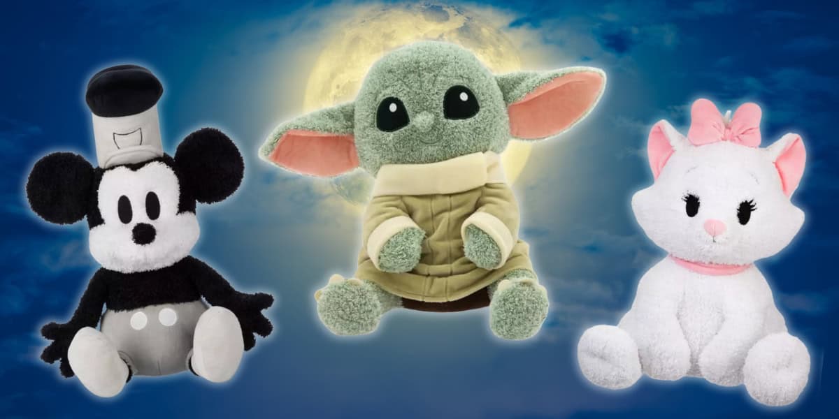 A trio of plush toys is displayed against a moonlit sky. From left to right: a vintage-style black and white mouse, a green creature with large ears and black eyes, and a white cat with a pink bow.