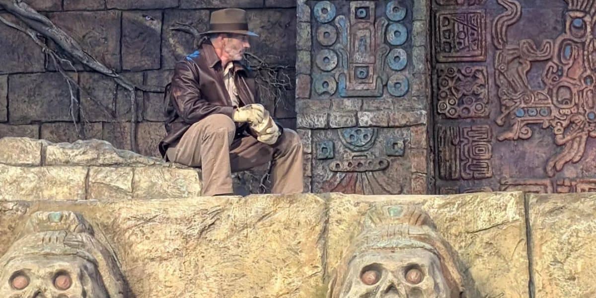Indiana Jones sits down as he waits for a broken special effect to be fixed during the stunt show.