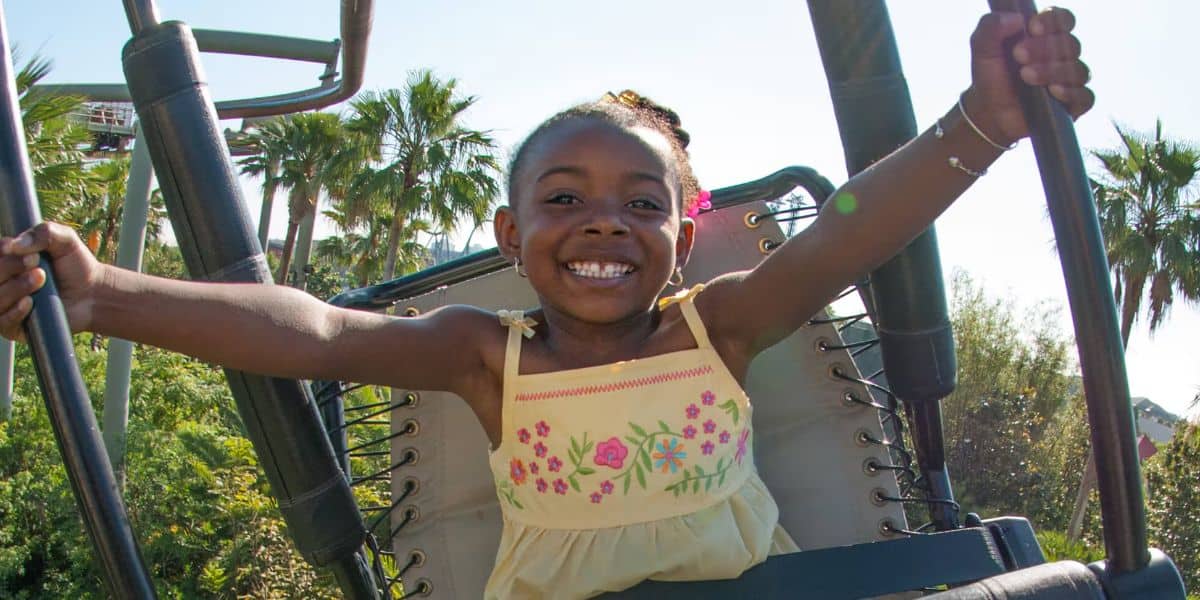 A young girl rides Pteranodon Flyers