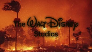 The image shows a wildfire scene with trees silhouetted against flames and an orange sky. The words "The Walt Disney Studios" are superimposed in the center.
