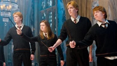 Fred, George, Ginny, and Ron holding out their wands