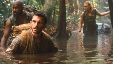 Jonathan Bailey, and Scarlett Johansson wading through a swamp in 'Jurassic World Rebirth'