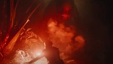 Mahershala Ali holding a red flare to the new mutant dinosaur in the 'Jurassic World Rebirth' trailer