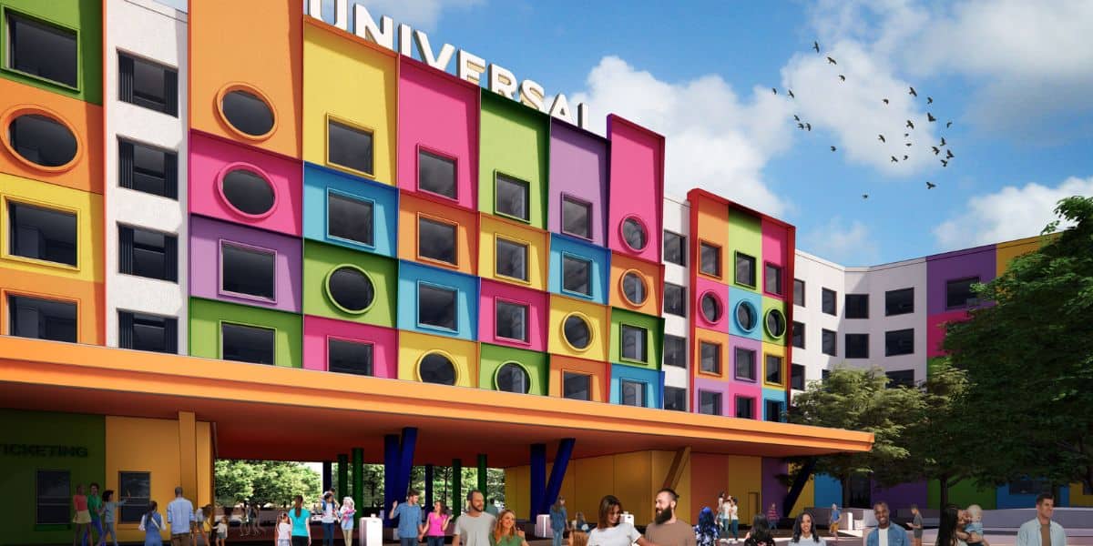 A colorful building with a large "Universal" sign features a facade of bright squares in various colors. Circular windows are set within the squares. People walk in front of the building, and birds fly against a blue sky.
