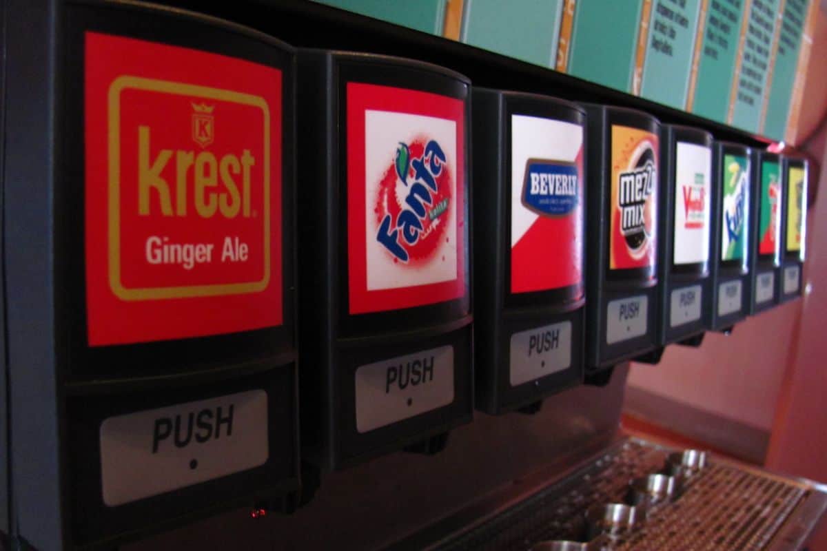 Close-up of a soda fountain machine at Club Cool, offering multiple drink options.