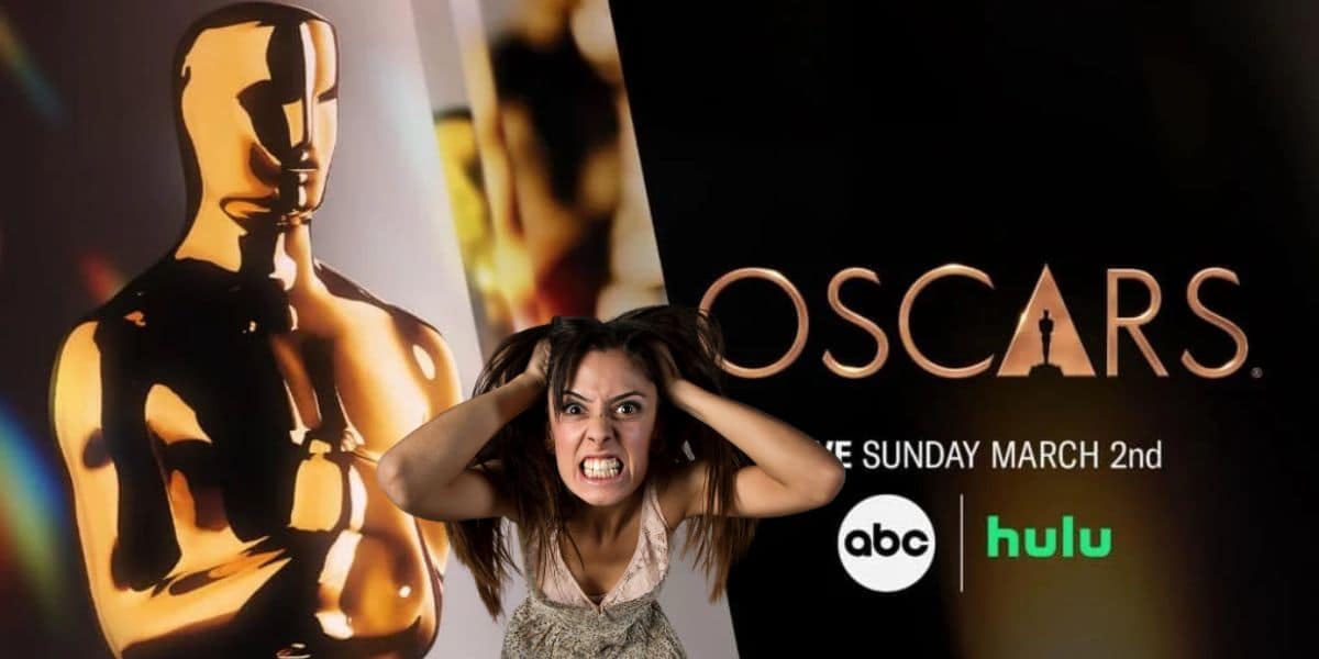 A frustrated woman in front of the promo image for the Oscars