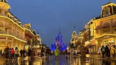 A rainy evening at Disney World's Main Street, showing the reflection of the street in the pavement.