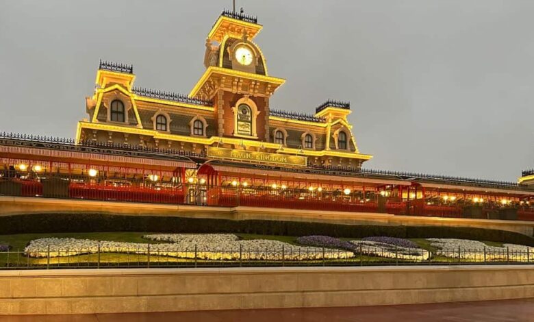 The reflection of the Magic Kingdom Park train station on the ground during a rainy day at Magic Kingdom.