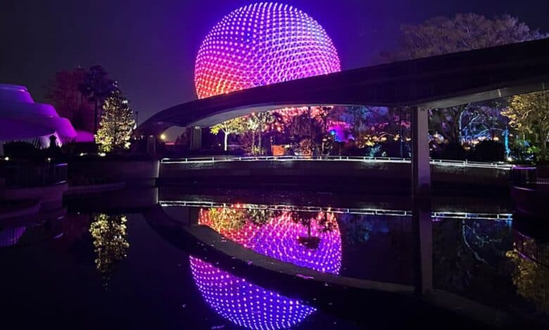 Spaceship Earth lights reflecting on the water at night at EPCOT, where a sudden EPCOT ride shutdown happened.