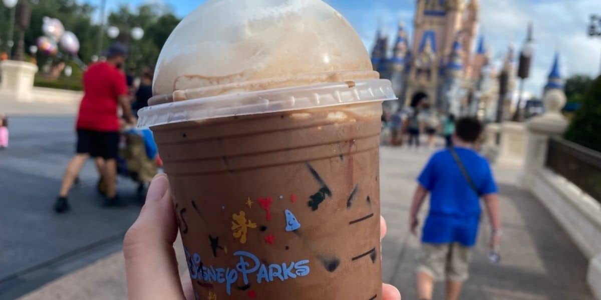 A Starbucks drink in front of Cinderella Castle at Magic Kingdom at Walt Disney World Resort.