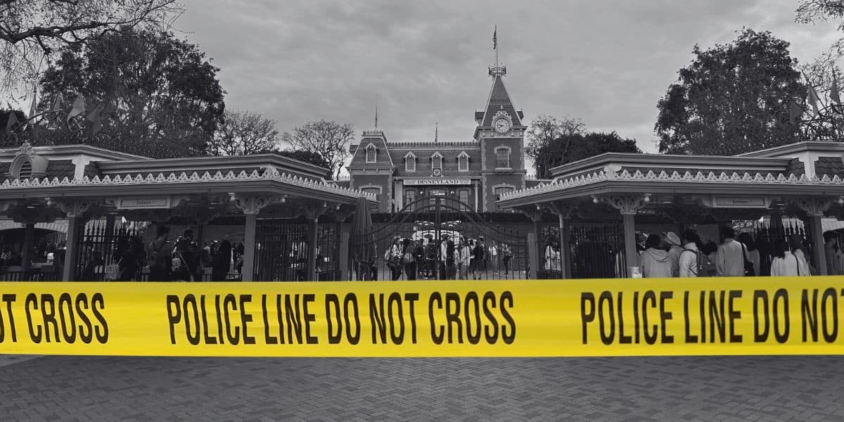 The entrance to Disneyland Park in black-and-white with police tape edited on top.