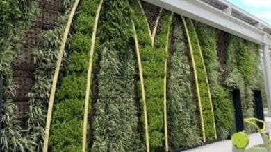 A green M mural made of plants on the wall of a McDonald's at Walt Disney World Resort.