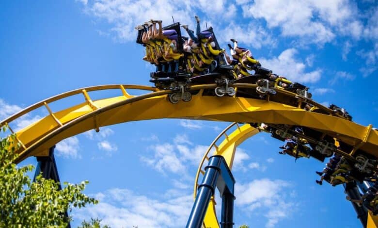 People ride a yellow and blue roller coaster at Six Flags Great America, where a Six Flags shooting took place.