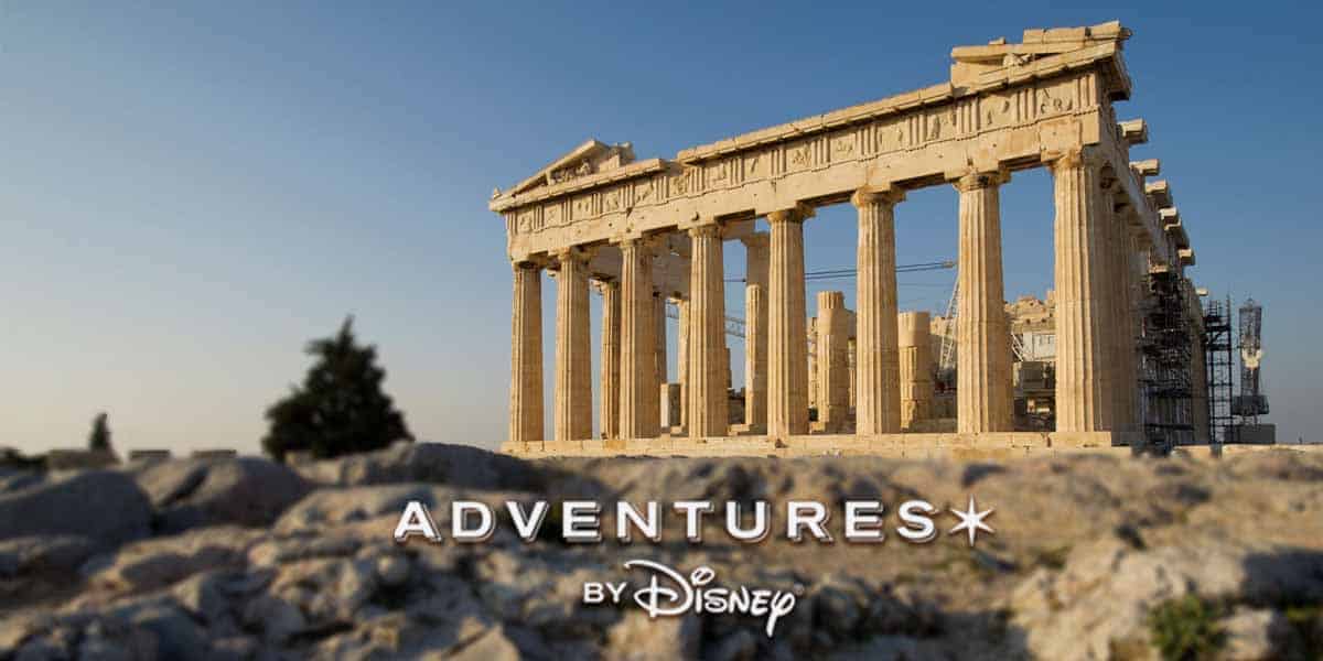 The Parthenon on the Acropolis in Athens, Greece, stands under a clear blue sky, inviting you to explore its wonders with Adventures by Disney. The text "ADVENTURES BY Disney" is overlaid at the bottom of the image.