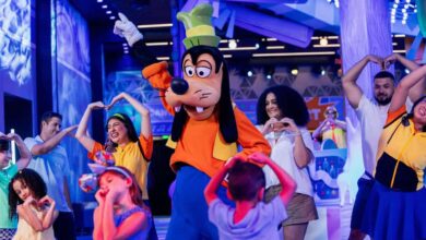 Goofy dances with young kids at EPCOT inside Disney World.