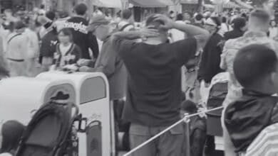 A black and white photo of crowds on a busy Main Street at Disneyland on May 27 2025