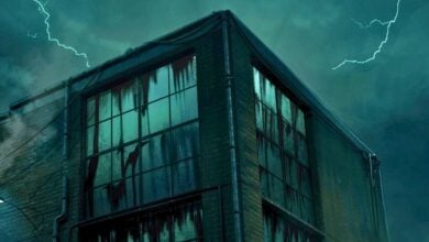 A dark, abandoned building with cracked windows and streaks of grime stands under a stormy night sky, illuminated by lightning bolts in the background as Universal Chicago prepares for Horror Unleashed.
